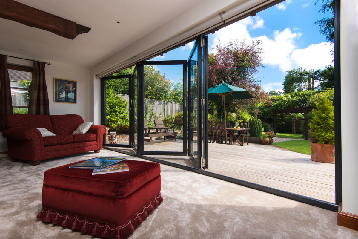 Contemporary aluminium bifold doors opening onto a garden